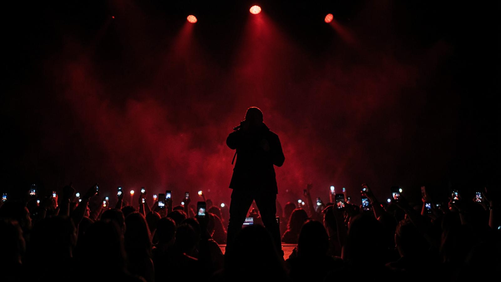 Performer on stage under crimson lights