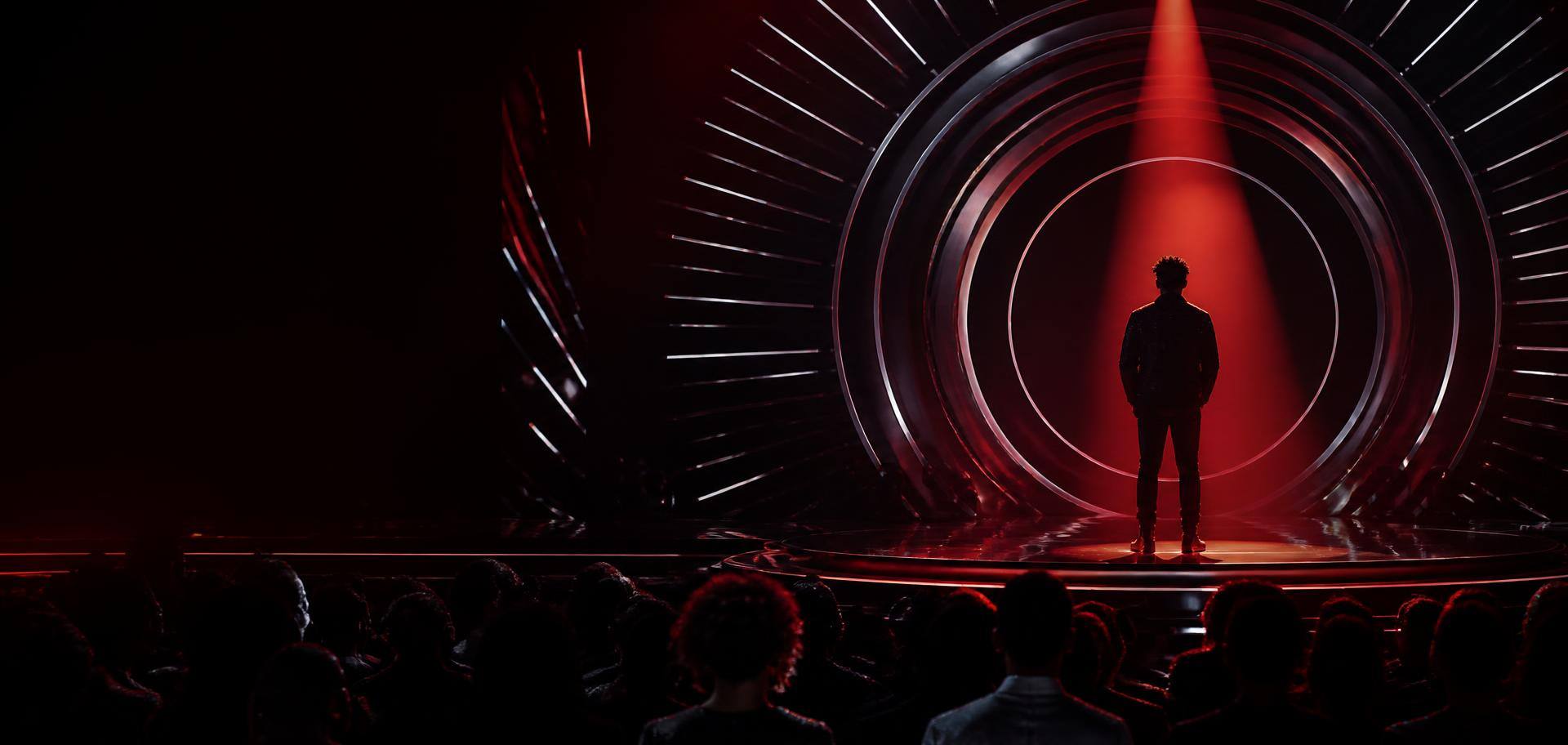 Performer standing beneath crimson lights on the vStarz stage